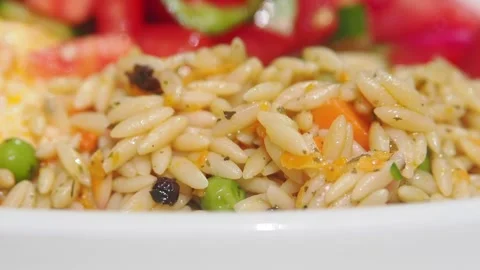 Cooking orzo pasta with vegetables in a kitchen Stock Footage 344916878