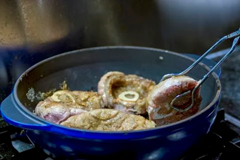 Cooking osso buco in pan Stock Photos