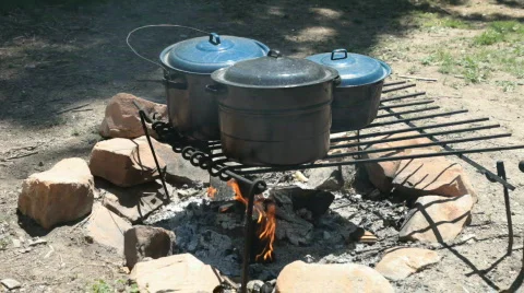 Cooking over fire pit P HD 0738 Stock Footage