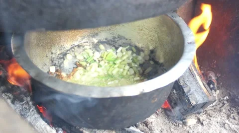 Cooking over open fire from above Stock Footage 54708378