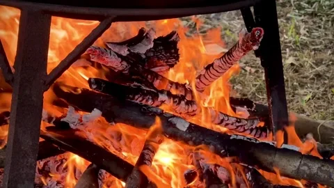 Cooking Over Open Fire in a Large Cauldron with Smoke and Flames. Stock Footage 296670159
