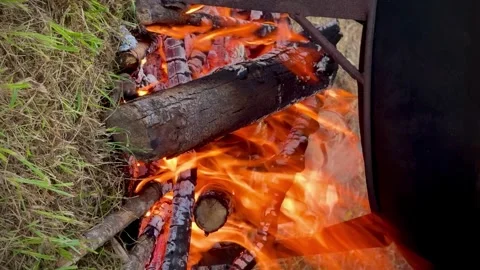 Cooking Over Open Fire in a Large Cauldron with Smoke and Flames. Stock Footage 296670160