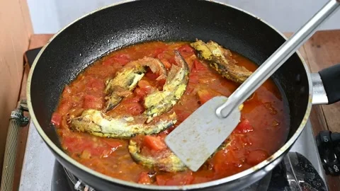 Cooking pabda fish in tomato, onion, oil. Slow motion video Stock Footage 209134155
