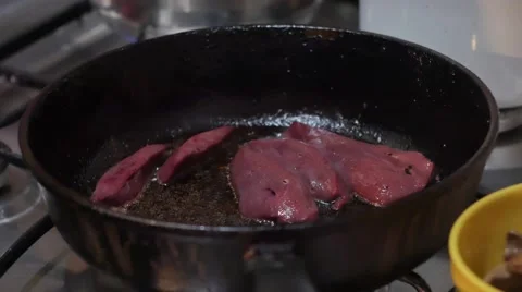 Cooking a pan full of raw livers in 4k UHD Stock Footage 67831104