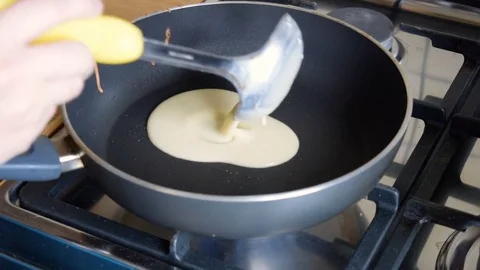 Cooking pancake on a hot frying pan Stock Footage