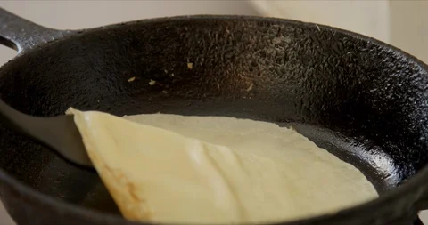 Cooking pancake on the stove with on ron pan 스톡 동영상 127375242