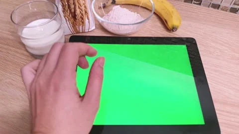 Cooking pancakes in the kitchen with tablet PC green screen. Flour, milk, banana Stock Footage 220764472