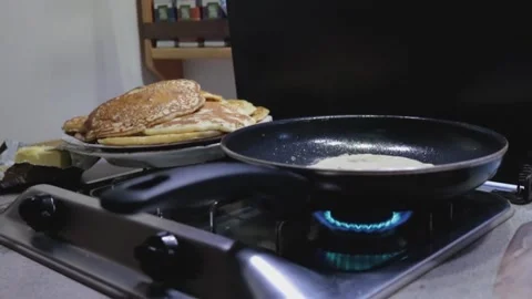 Cooking pancakes on open fire Stock Footage 231872425