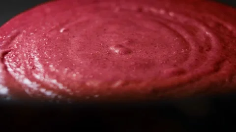 Cooking pancakes of red pancake batter in a pan. Process of preparing colorful Stock Footage 144904729
