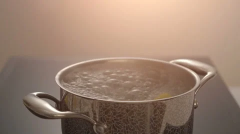 Cooking pasta in boiling water on electric stove Stock Footage 67994579
