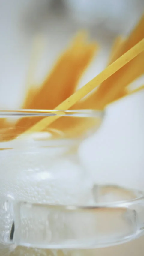 Cooking pasta in bubbling water within a transparent saucepan on the stoveto Stock Footage 331539851