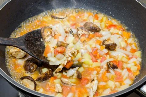 Cooking pasta with chicken and meat gravy on stove 写真素材