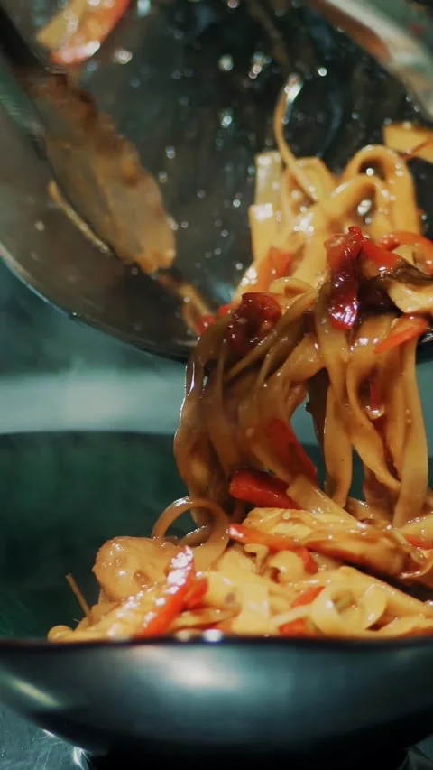 Cooking pasta. close-up. the chef is putting the freshly made pasta in a Stock Footage 323368719