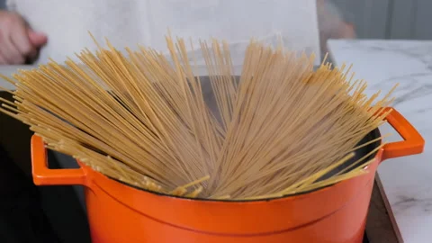 Cooking pasta inside boiling water, iron cast pot Stock Footage 204996682