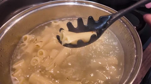 Cooking Pasta in a Pot for your dinner or lunch is a simple yet fulfilling task Stock Footage 310632360