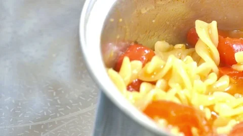 Cooking pasta with red paprika. Pan right Stock Footage 74121553