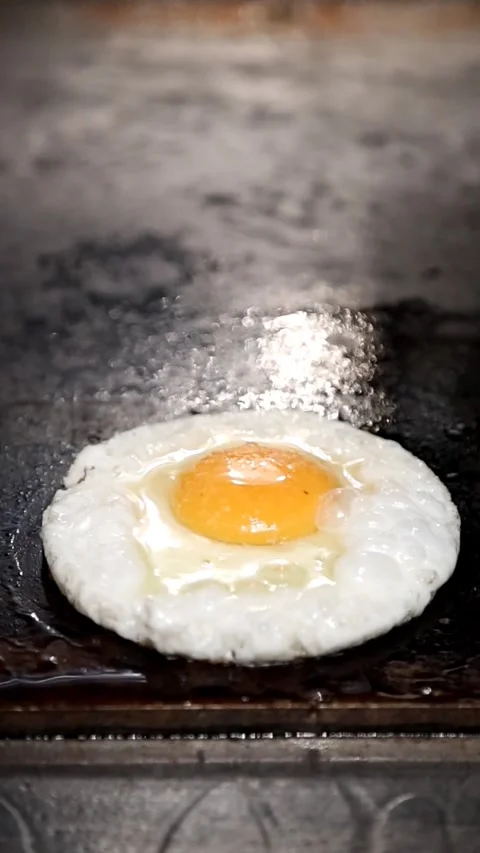 Cooking a Perfect Fried Egg with a Metal Ring Mold Stock Footage 298199400