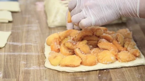 Cooking the pie, spread on the dough in sugar apricots Stock-Footage 69993930