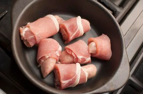 Cooking pigs in blankets Stock Photos
