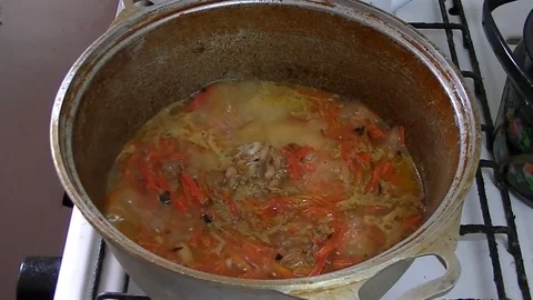 Cooking pilaf in a cauldron 1 Stock Footage 106342011
