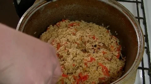Cooking pilaf in a cauldron 2 Stock Footage 106342069
