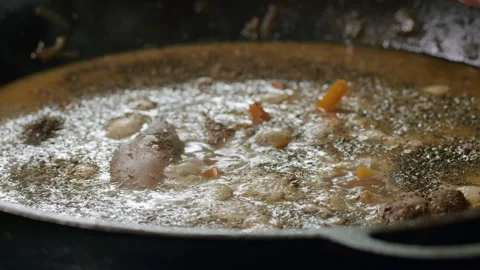 Cooking pilaf in a cauldron. Close-up Stock Footage 153392704