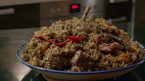Cooking pilaf in a cauldron. Close-up Stock Footage 153392763
