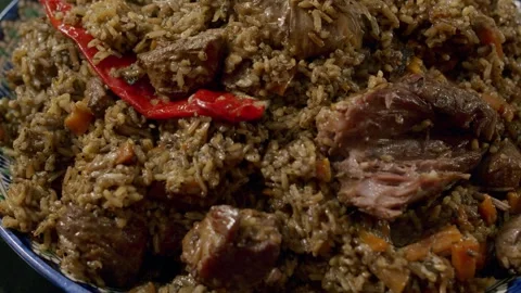 Cooking pilaf in a cauldron. Close-up Stock Footage 153392768