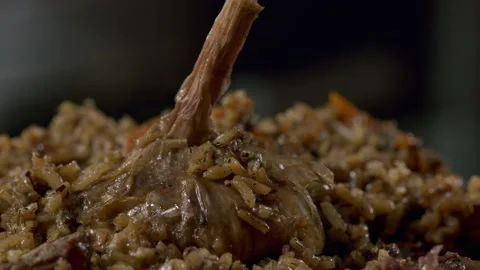 Cooking pilaf in a cauldron. Close-up Stock Footage 153392807