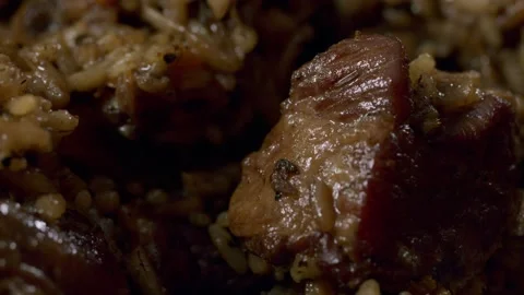 Cooking pilaf in a cauldron. Close-up Stock Footage 153392816