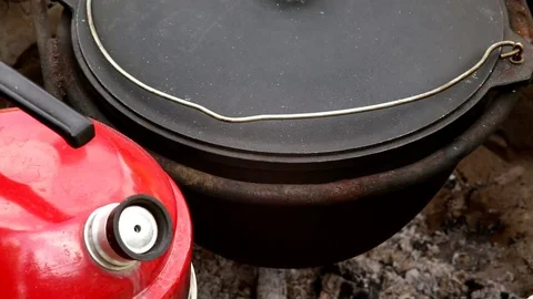 Cooking pilaf in a cauldron outside Stock Footage