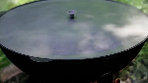 Cooking pilaf in a cauldron at a stake Stock Footage 134294778
