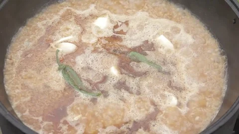 Cooking of pilaff with lamb. Meat with vegetables and hot green pepper Stock Footage