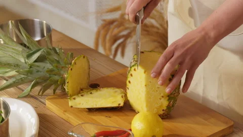 Cooking. Pineapple. The cook cuts pineapple. Cut off crusts from pineapple Stock Footage 162620529