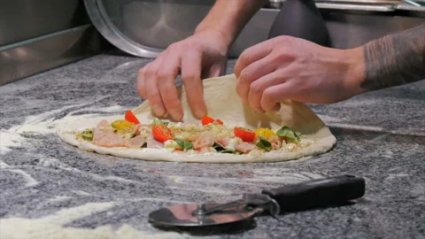 Cooking pizza and calzone in a restaurant Stock Footage 85831153