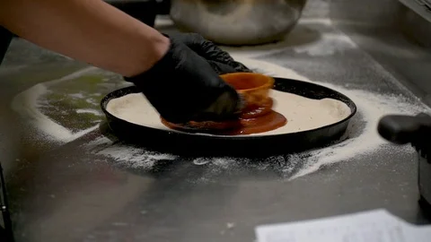 Cooking pizza in the frame close-up hands and pizza Stock Footage 127057951
