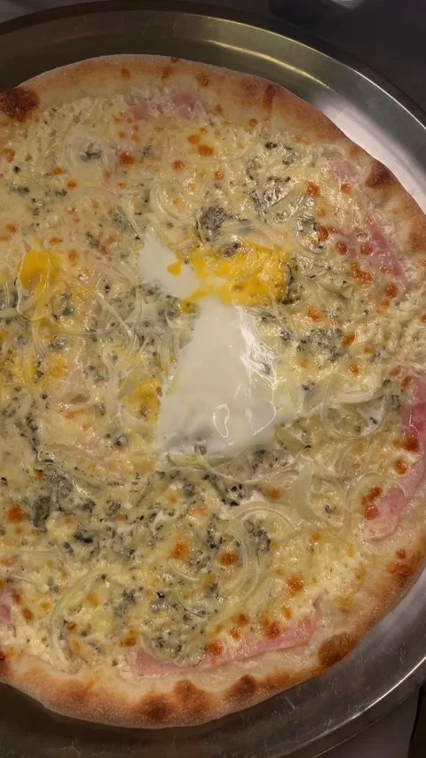 Cooking pizza in a warm kitchen close-up with cheese and crust visible. yellow. Stock Footage 341661636