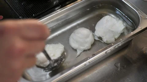 Cooking poached eggs. eggs are cooled in water before serving Stock Footage 291256762