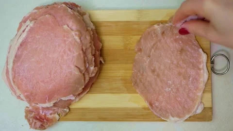 Cooking pork meat chops. Meat Tenderizer in action, close-up. Stock Footage 150679624