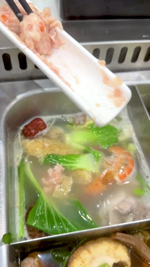 Cooking Pork Paste in a Boiling Thai Shabu Shabu Hot Pot Stock Footage 334360689