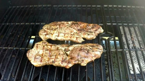 Cooking pork steaks on the grill Stock Footage 37667864