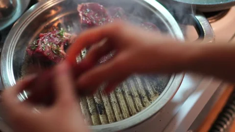 Cooking pork on a stove grill using animal fat for a delicious dish Stock Footage 268183251
