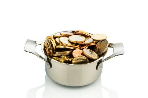 Cooking pot with coins Foto stock
