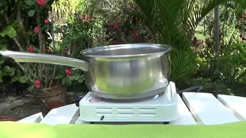 Cooking pot cooking outside with a fly Stock Footage 138643721