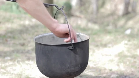 Cooking in a pot over campfire Stock Footage 88809508