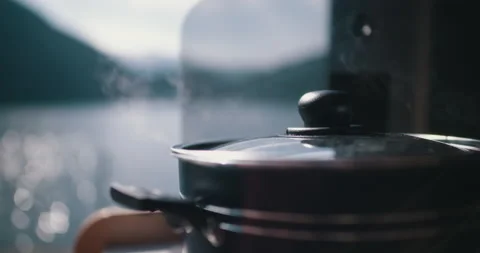 Cooking pot steaming inside camper with fjord view norway 4k Stock-Footage 153492269