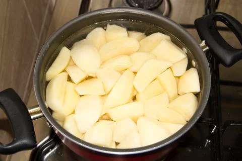 Cooking Potatoes in Cooking Pot Stock Photos