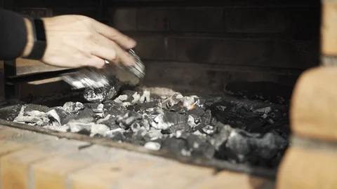 Cooking Potatoes in Fireplace Stock Footage 120132311