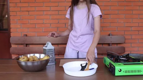 Cooking potatoes outdoors with simple tools and a gas stove Stock Footage 297358369