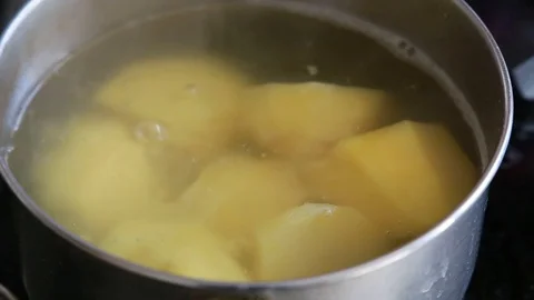 Cooking potatoes in a pan. Close up. Boiling water Stock Footage 112874801